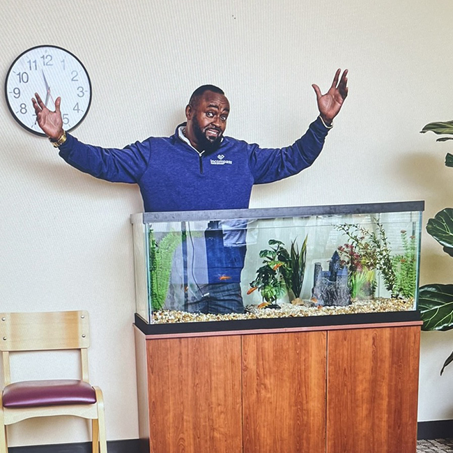Simon behind a fish tank