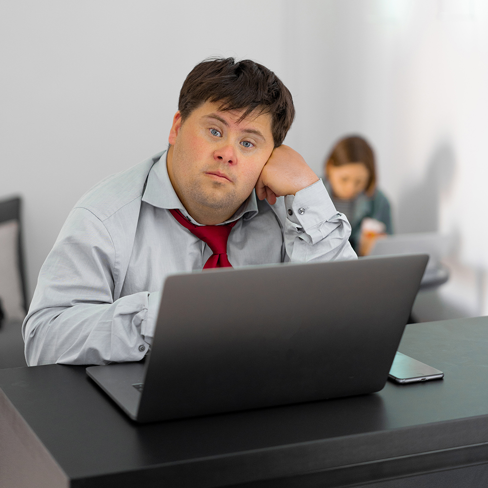 young man at desk with laptop