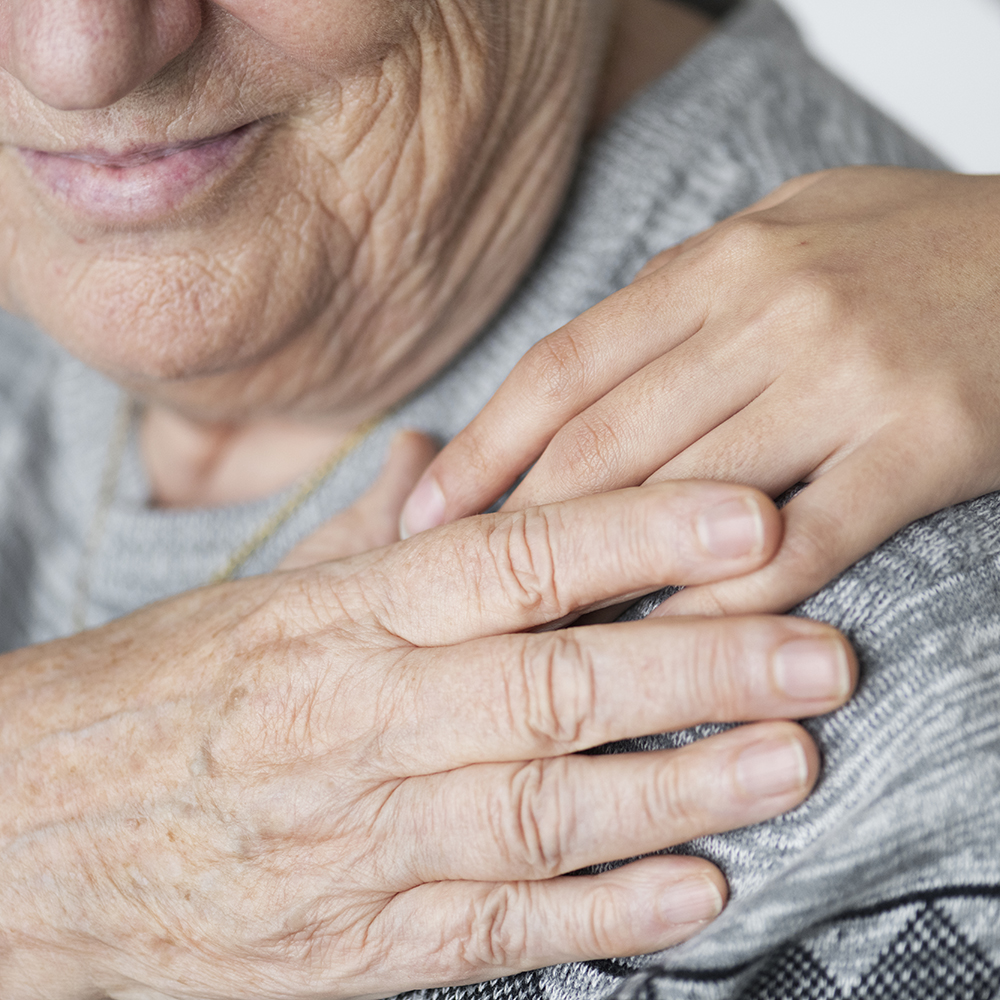 Elderly holding a hand on the shoulder
