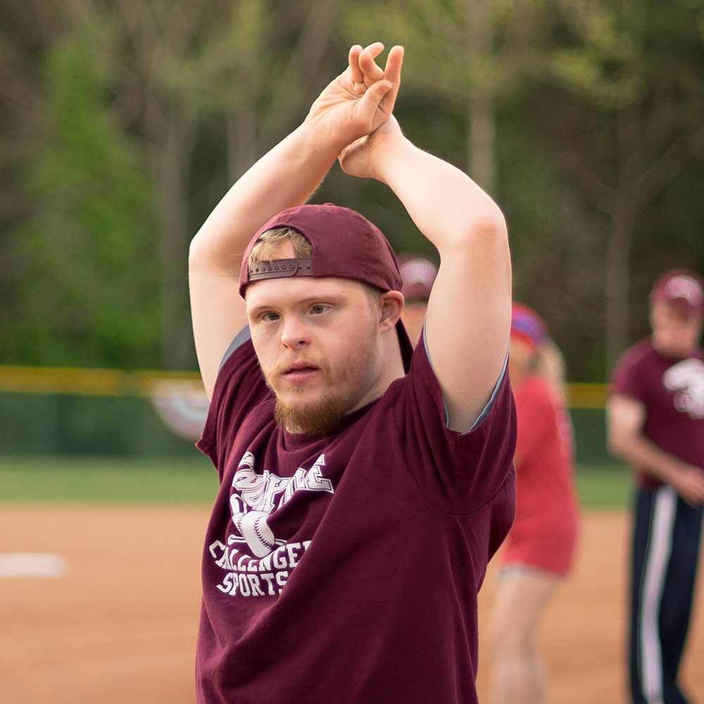 young man stretching on baseball field